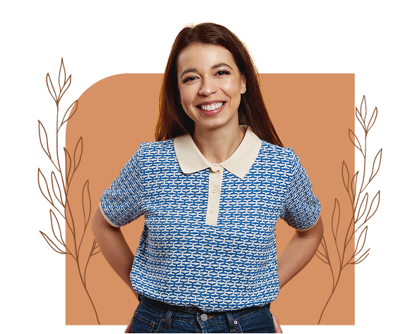 Smiling young woman standing with her hands on her hips in front of a decorative background